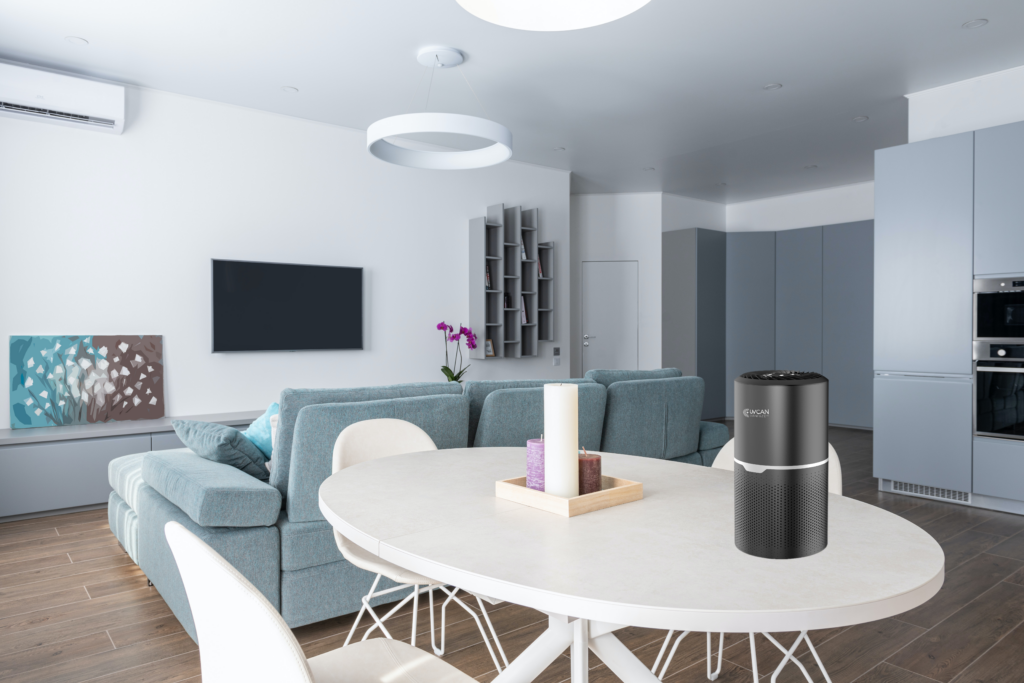 Picture of an UV air purifier on the table in a living room/dining room combination setting.